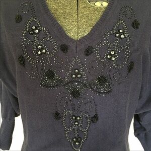 Navy blue beaded sweater.